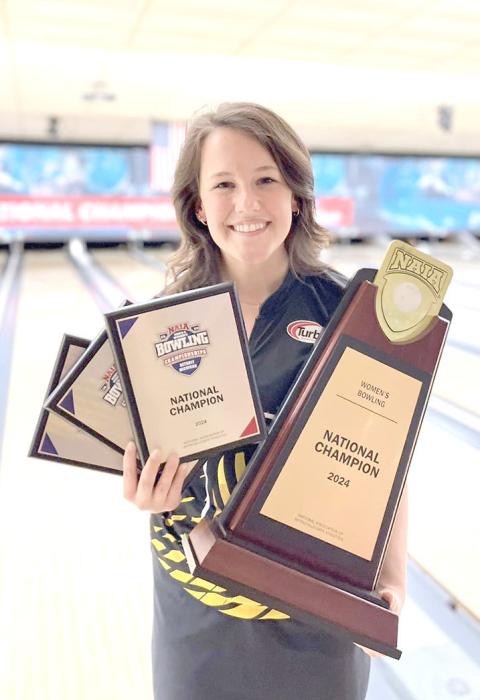 Addy proudly displays the team trophy for winning the NAIA national championship as well as her individual plaque for the team title and her plaques for being named to the All-Tournament Team and MVP. (Submitted photo)